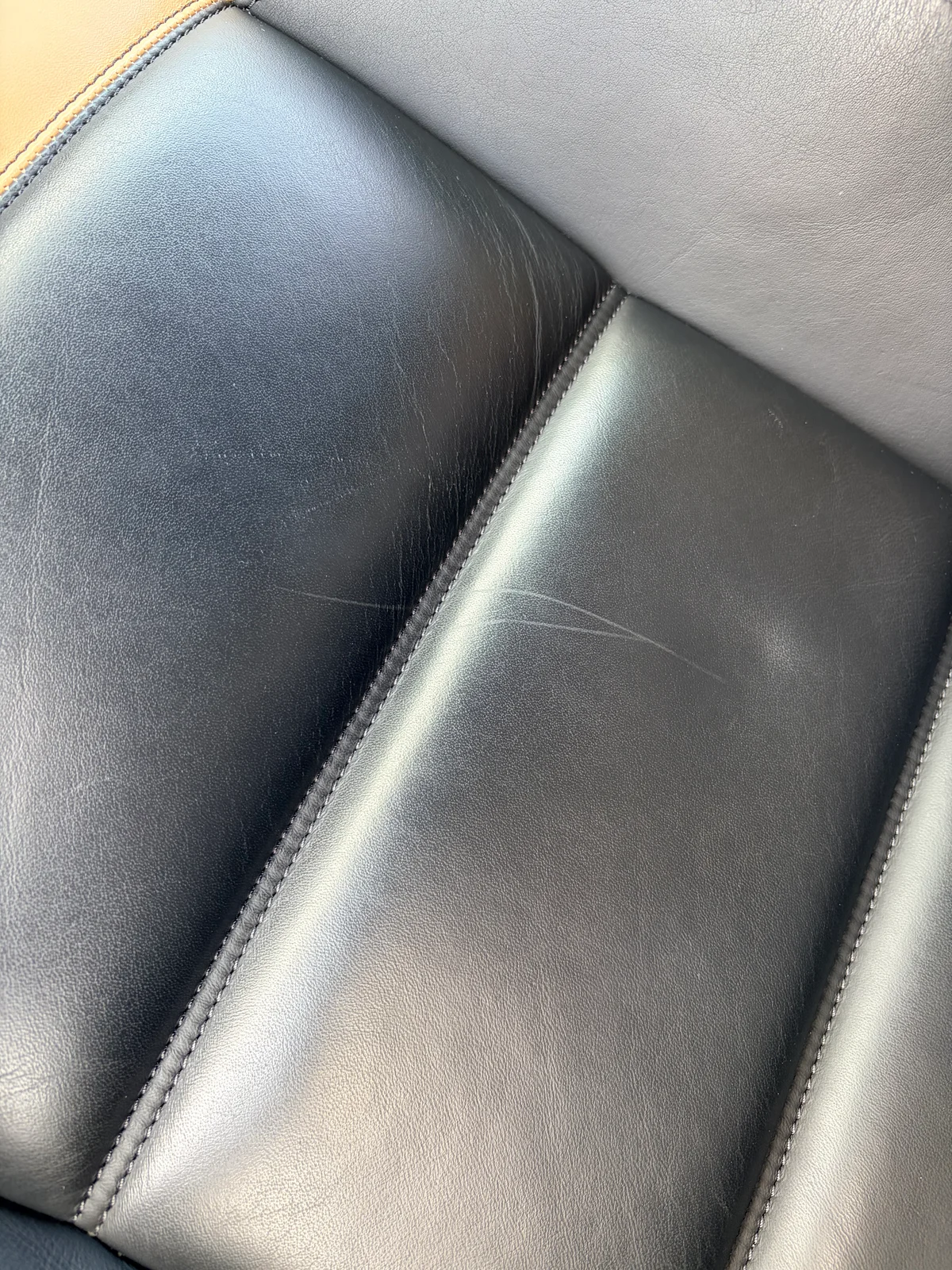 Mercedes-Benz SLS AMG GT Roadster black leather seat cushion before preservation — denim friction had worn and marked the protective finish