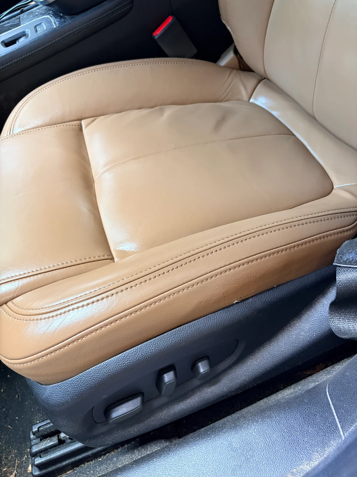 2015 Buick LaCrosse driver's seat after restoration — consistent tan color and repaired leather and vinyl surfaces