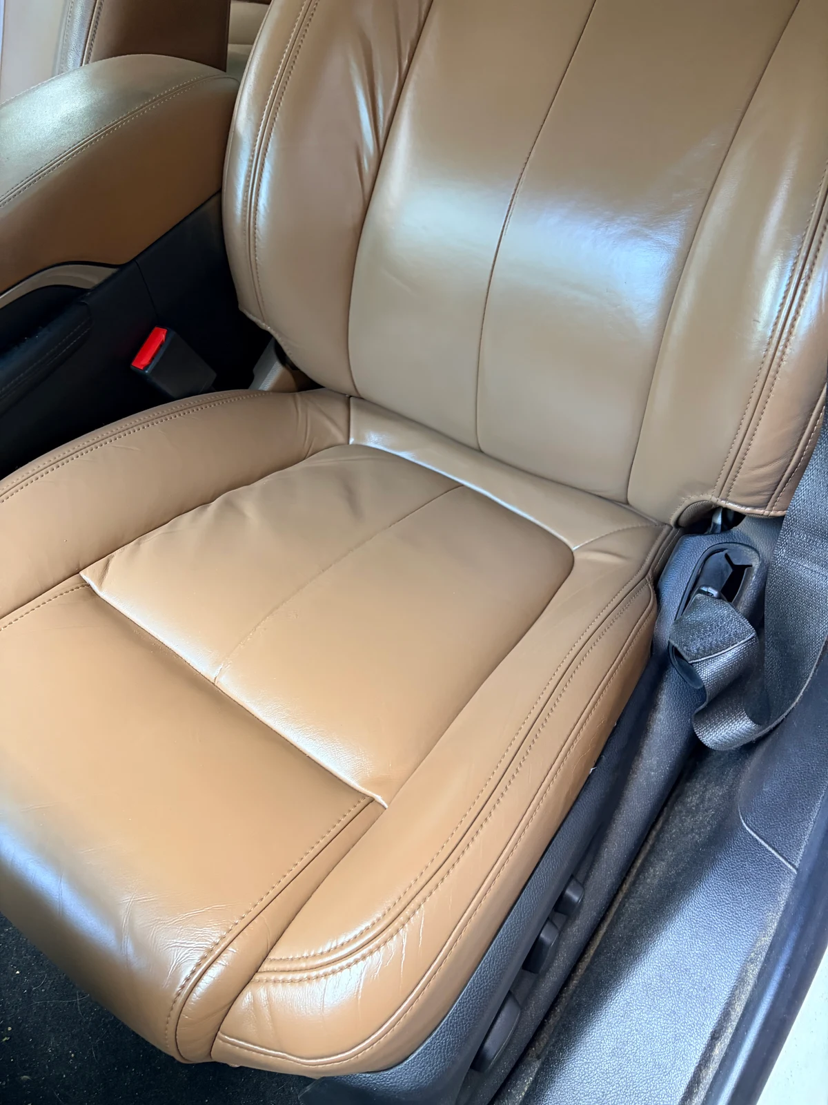 2015 Buick LaCrosse driver's seat after leather and vinyl restoration — even tan color and consistent finish across backrest and cushion