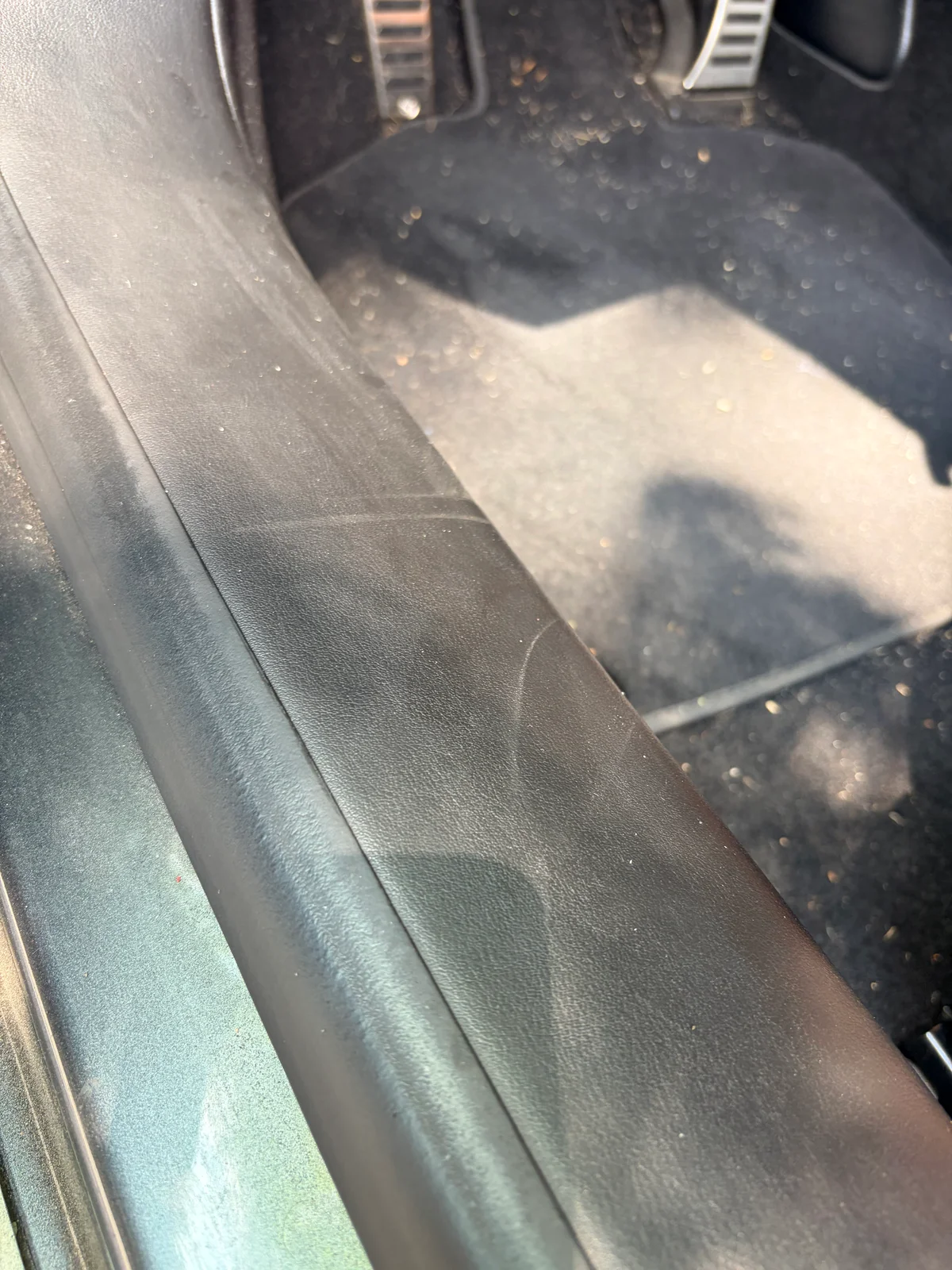 Lamborghini Huracán leather entry panel before restoration — close view of shoe scuff marks from normal entry and exit
