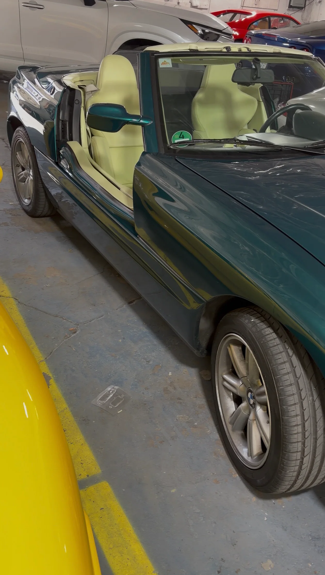 BMW Z1 roadster with retractable doors in lowered position showing Lemon leather interior from the side — collector vehicle preserved by Leather & Vinyl Care NYC