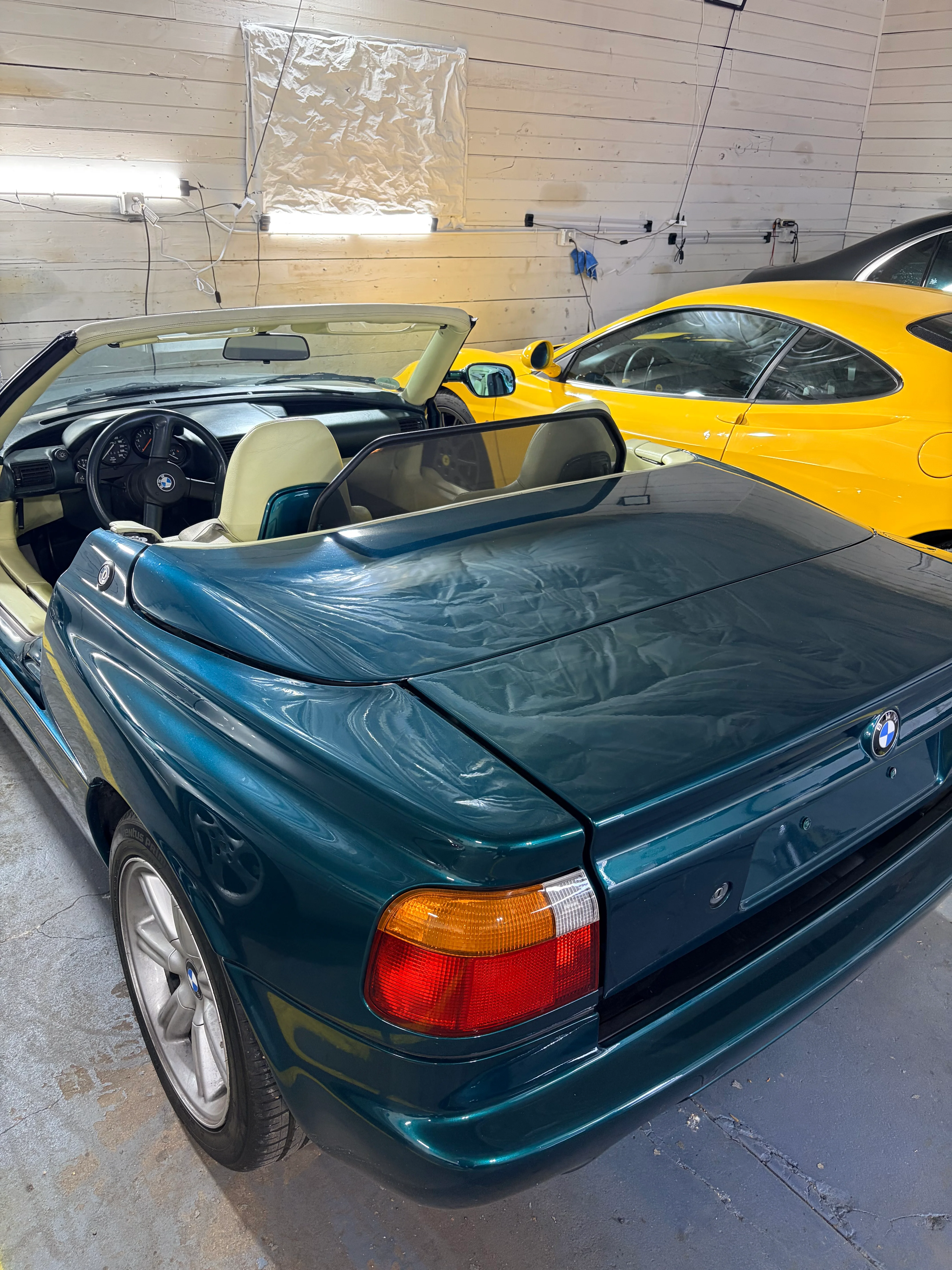 BMW Z1 roadster in dark green metallic — rear three-quarter view in garage showing distinctive Z1 body styling
