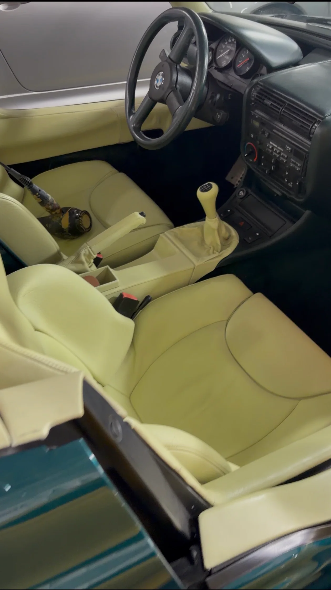 BMW Z1 interior after preservation — consistent Lemon leather tone across seats, center console, gear surround, and handbrake; steering wheel and instrument cluster visible