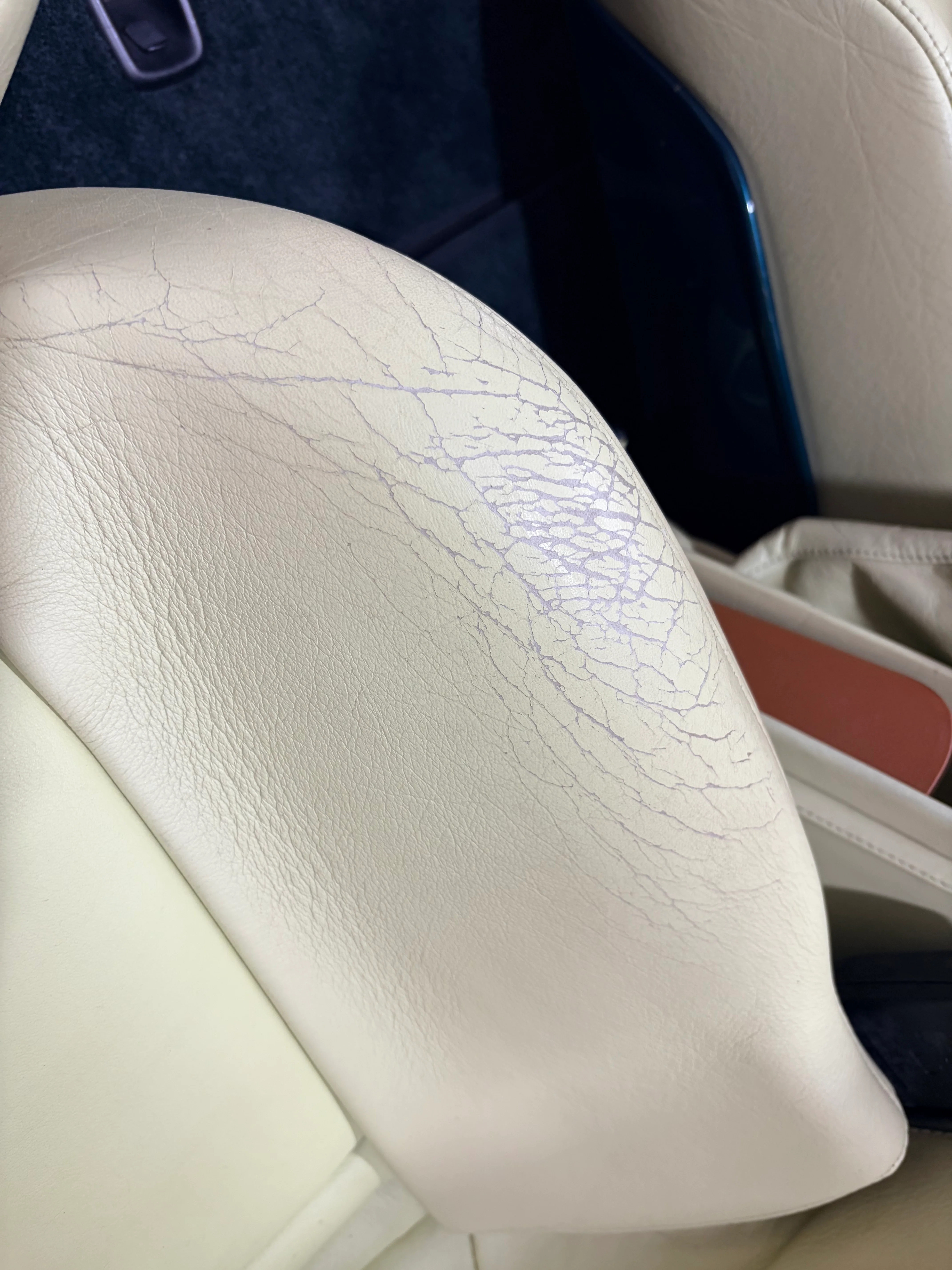 BMW Z1 Lemon leather seat back before preservation — pronounced surface crazing with blue-grey vein pattern visible across leather face
