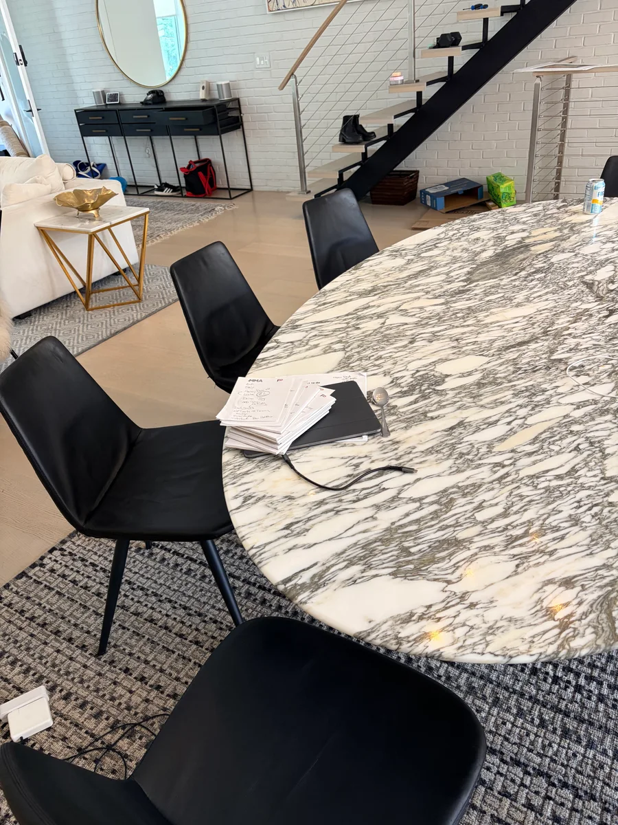 Restored black leather chairs surrounding a dining table in a Clinton Hill home