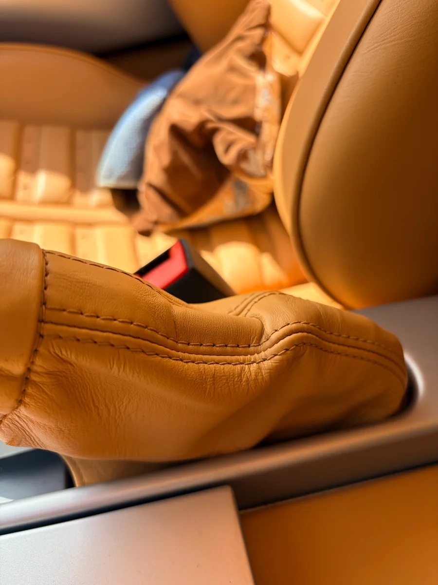 Ferrari 360 Modena handbrake gaiter after leather restoration — beige leather restored and color-matched