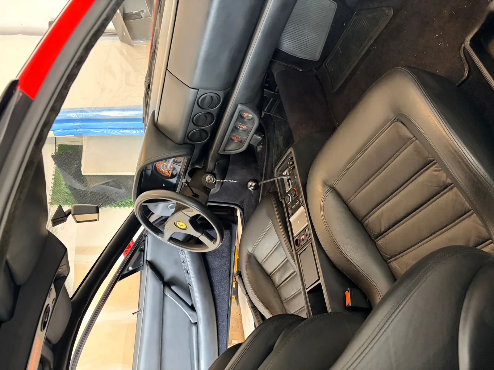 1992 Ferrari 512 TR interior detail showing leather wear and cosmetic imperfections before restoration