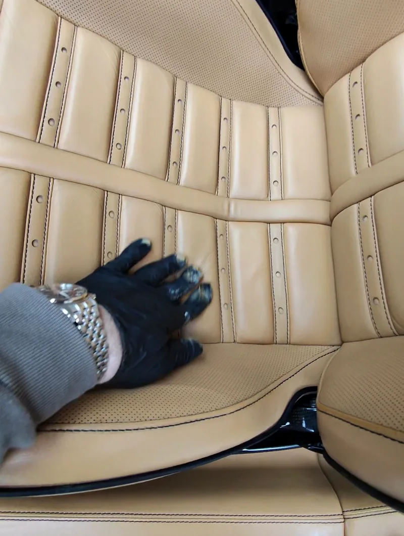 Ferrari 599 GTB Fiorano driver seat leather restored — beige leather seat cushion and bolster after repair and color restoration