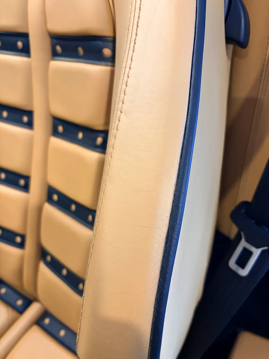 Ferrari F430 seat back after leather restoration — Cuoio leather and black Daytona inserts with even color and clean lines
