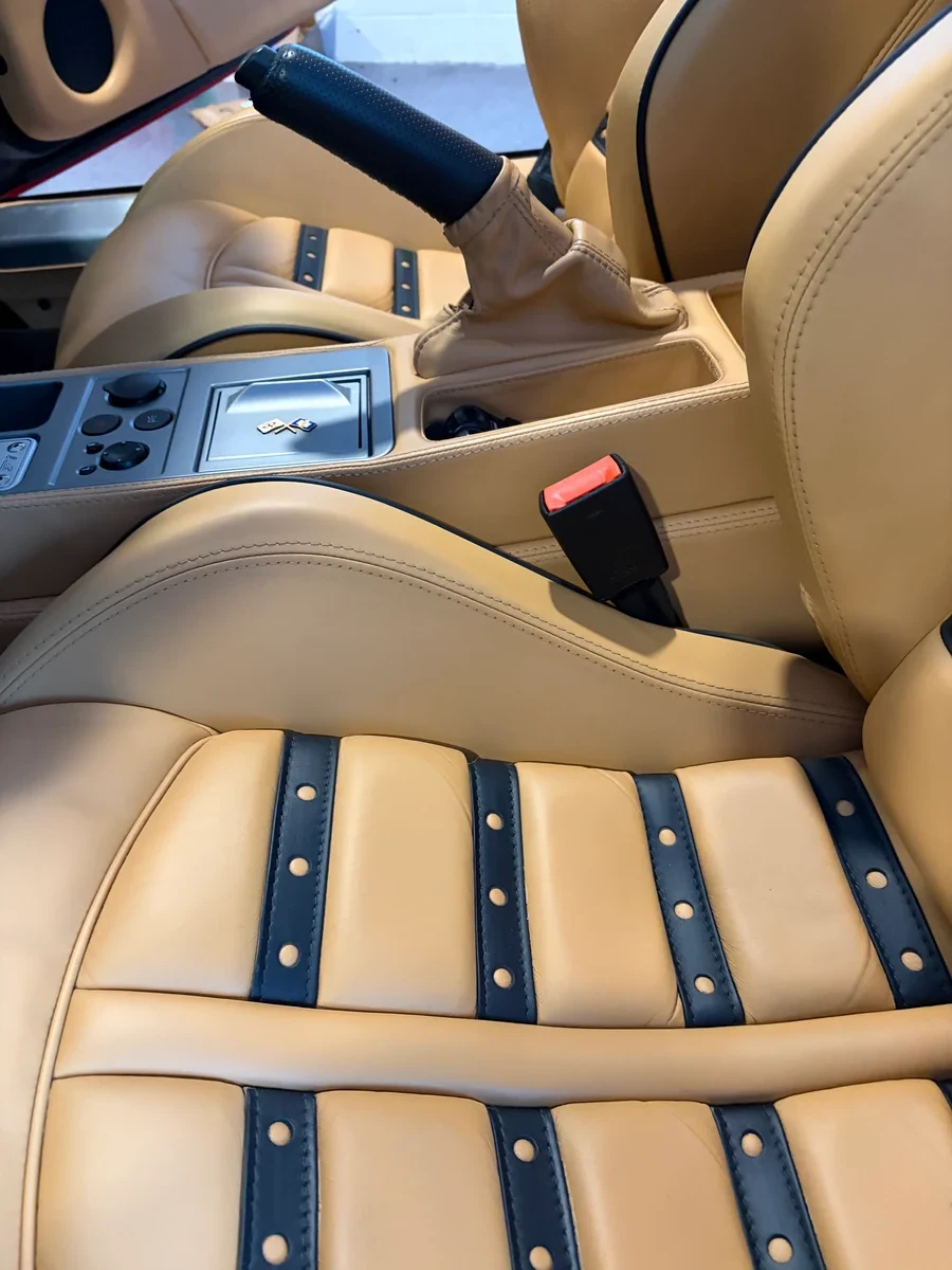 2007 Ferrari F430 Spider interior after restoration — both Daytona seats with correct OEM Cuoio leather color, black inserts and piping restored