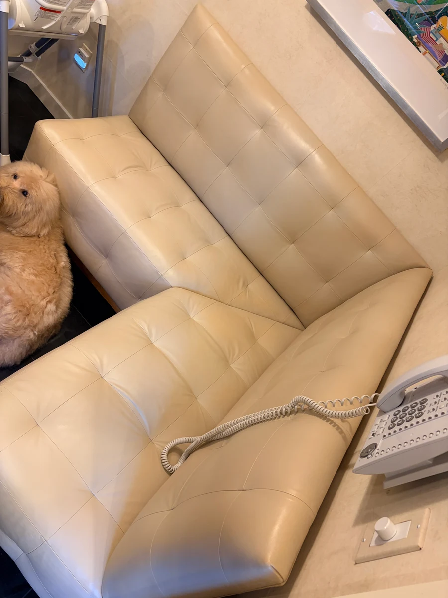 Built-in cream leather kitchen banquette after restoration — clean uniform color across the full unit after professional leather restoration in New York