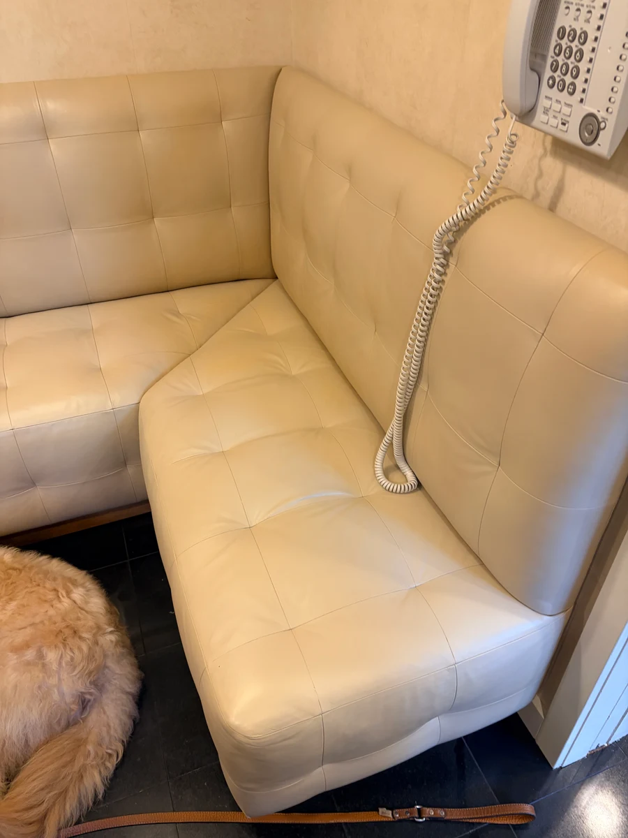 Built-in cream leather kitchen banquette restored after cracking and color loss in New York