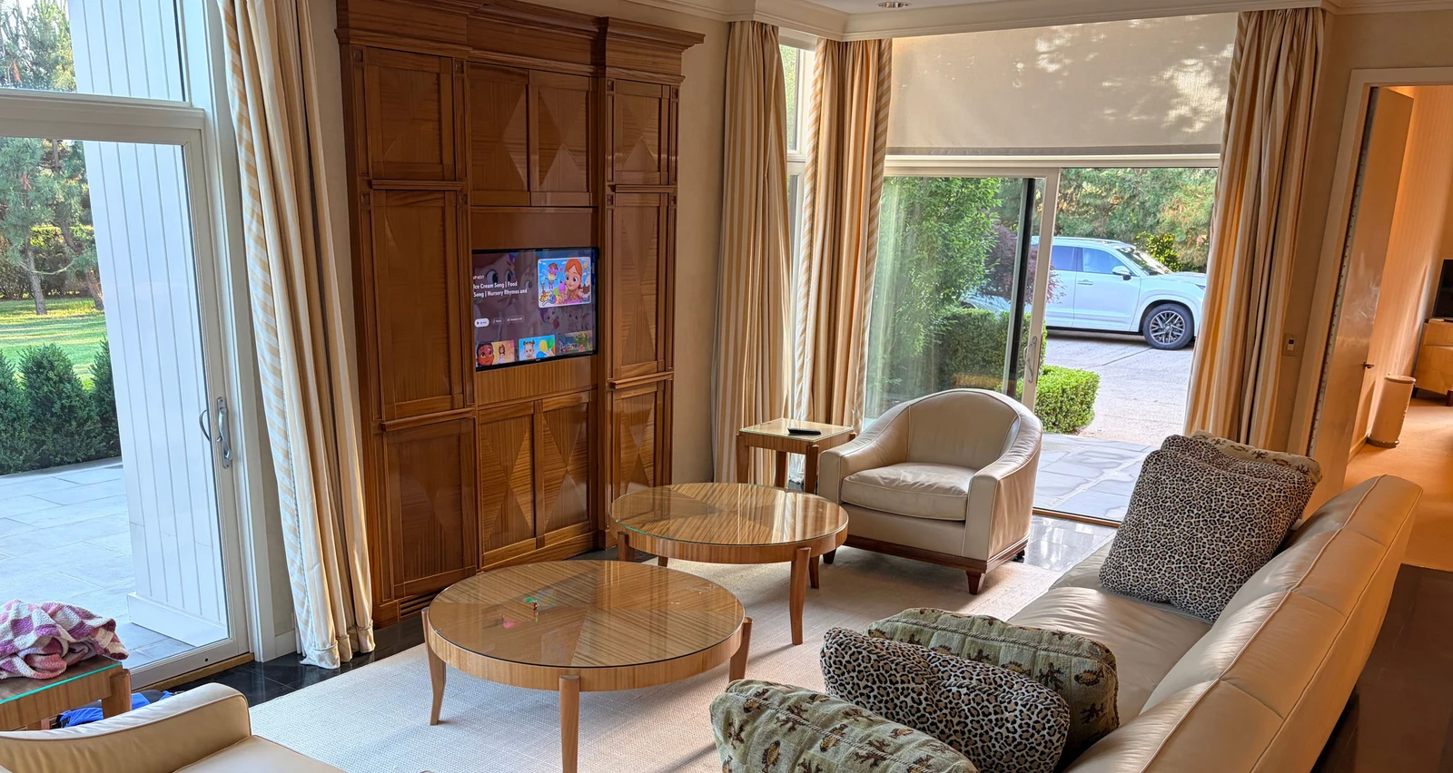 Luxury leather furniture collection after professional restoration in New York — sofa and club chairs in full-room view with custom color and white contrast piping preserved