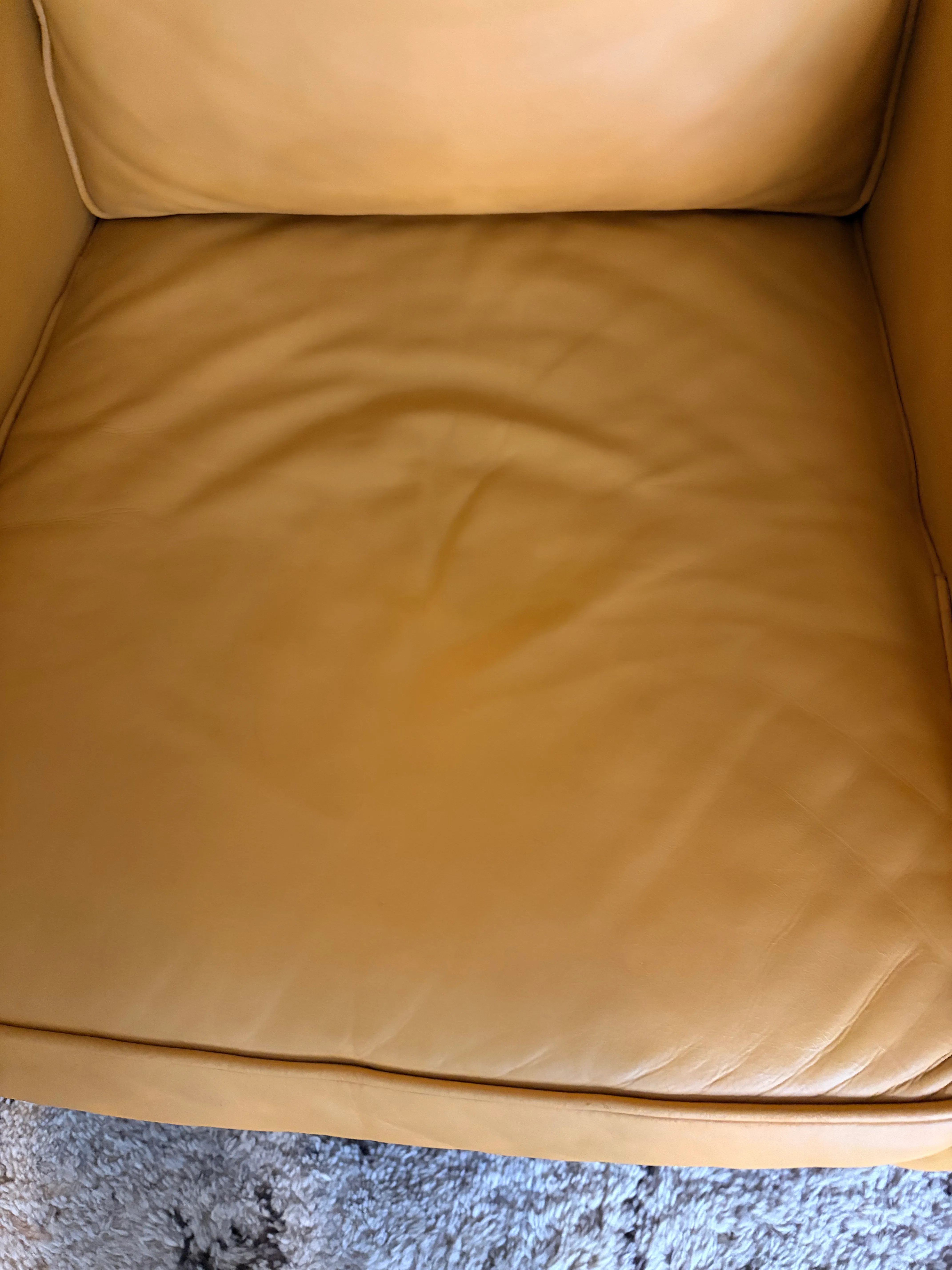 Mitchell Gold Hunter leather chair seat back panel after restoration — smooth even Saffron color, no cracking, natural leather character preserved