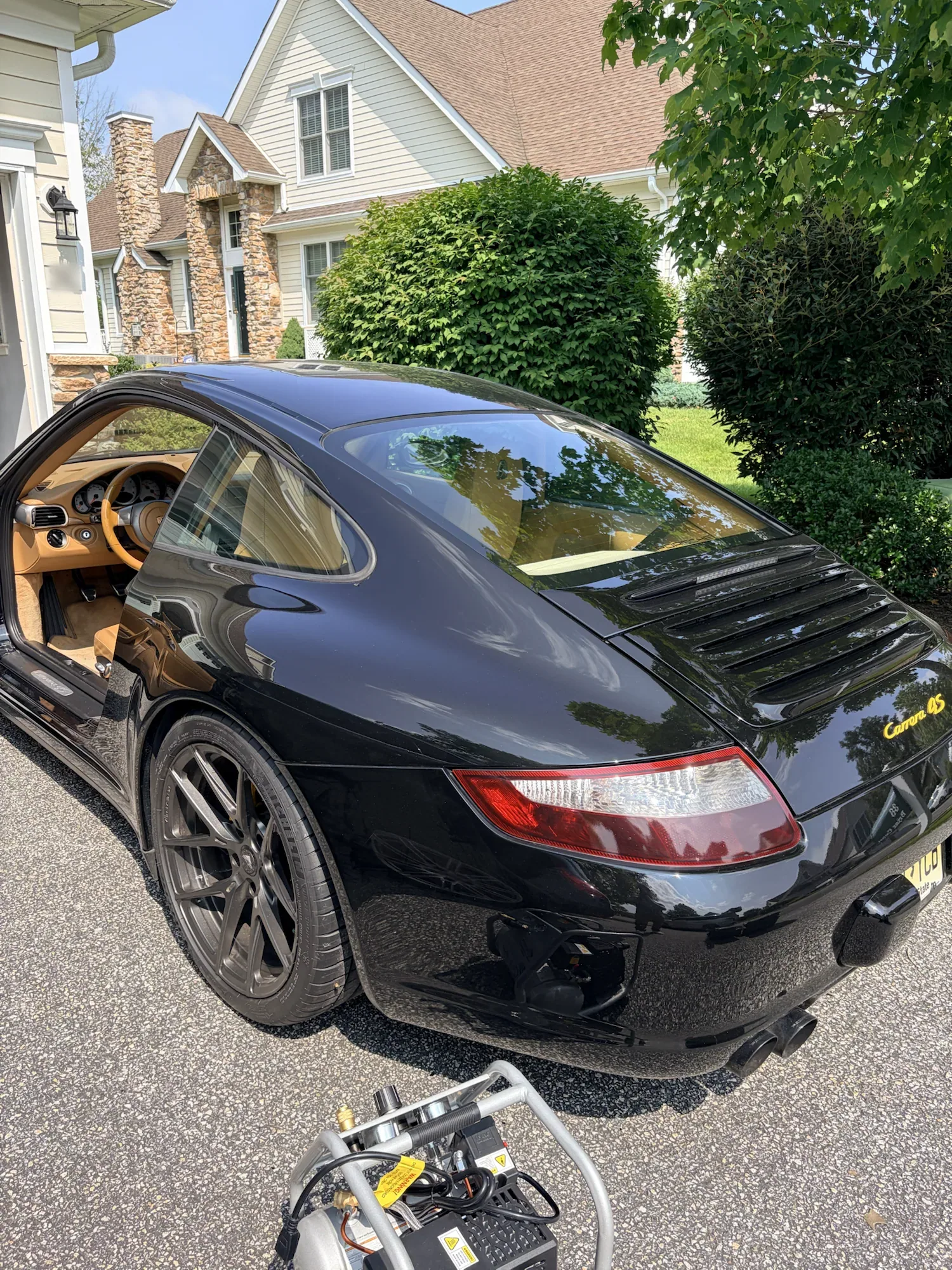 Black 2008 Porsche 911 Carrera 4 photographed before its tan interior restoration
