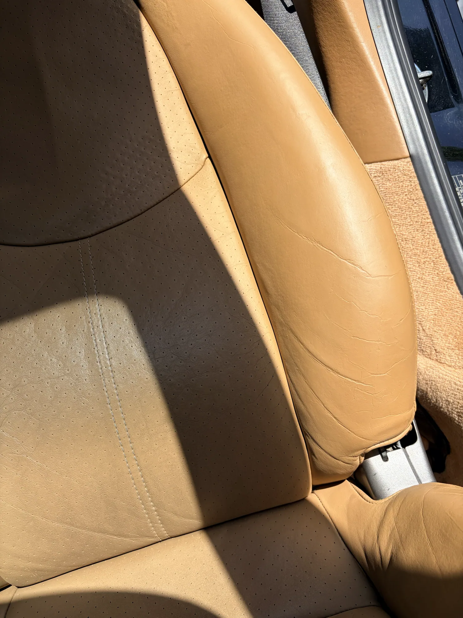 Wider view of the restored tan leather seat and bolster in the 2008 Porsche 911 Carrera 4