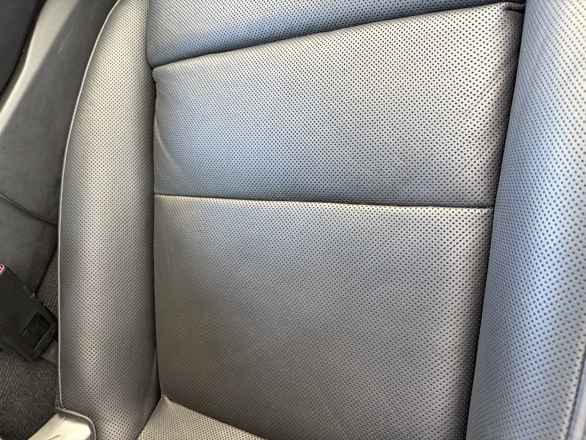 Porsche 911 Targa 4 seat cushion perforated leather after restoration — uniform black color across the full cushion surface, perforations intact