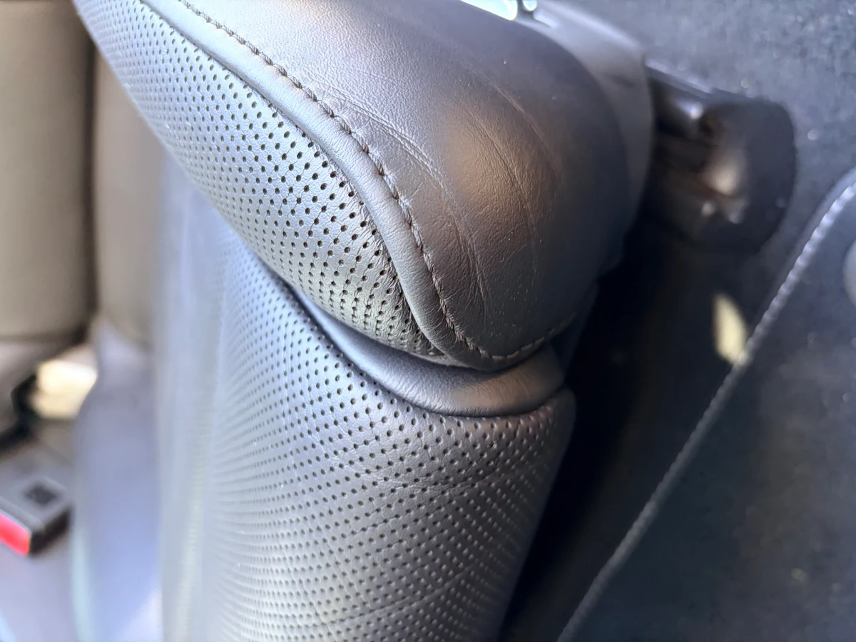 Porsche 911 Targa 4 seat lower bolster before restoration — leather cracking and finish breakdown at the junction between seatback and seat cushion