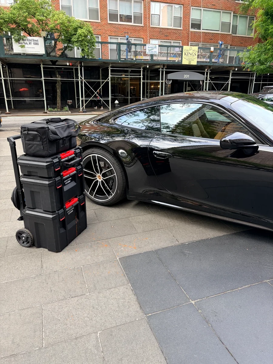 2025 Porsche 911 parked on Manhattan street with restoration equipment — on-site leather repair by Leather & Vinyl Care NYC