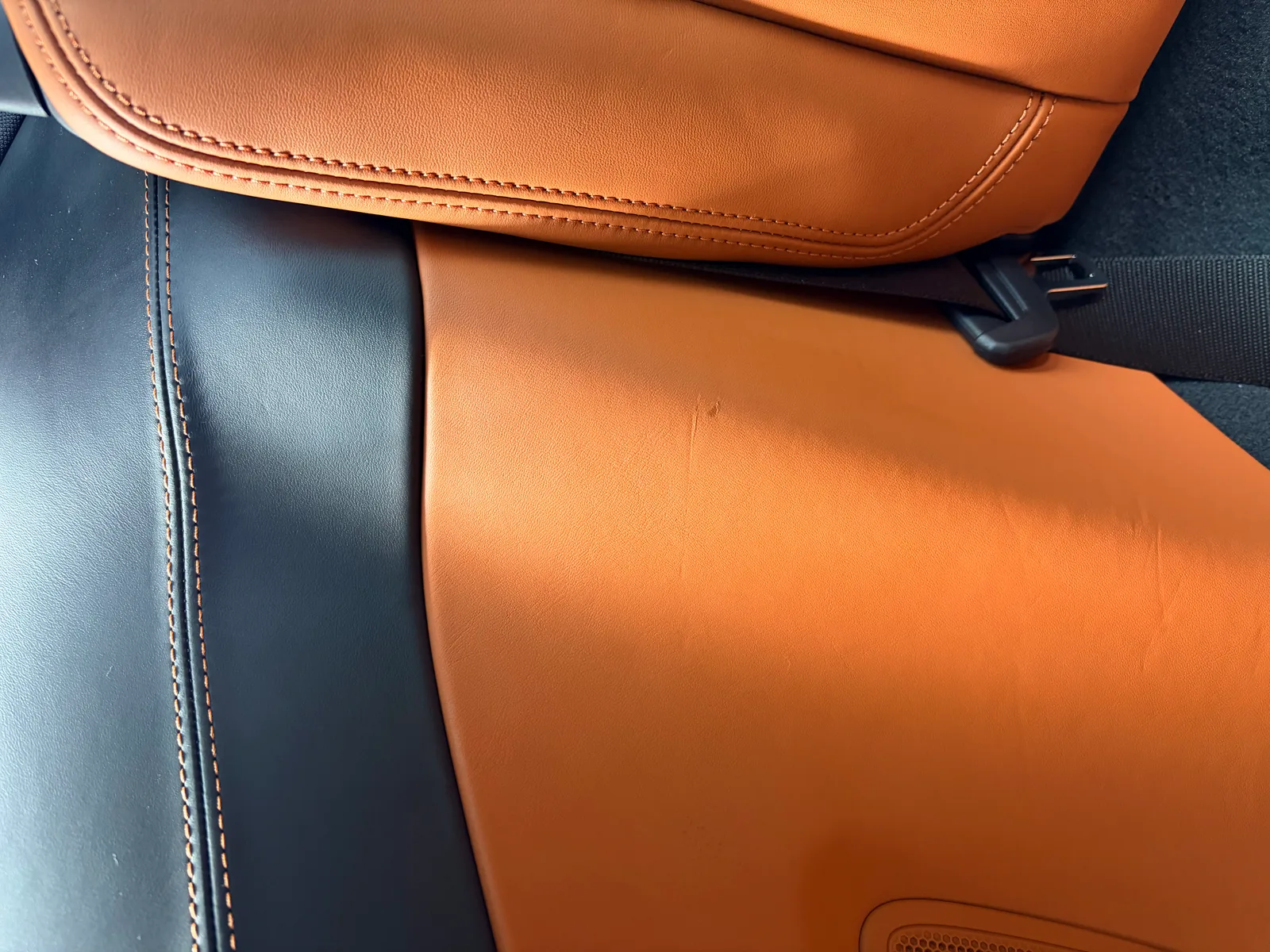 Porsche Cognac leather scratch before repair — rear side panel damage