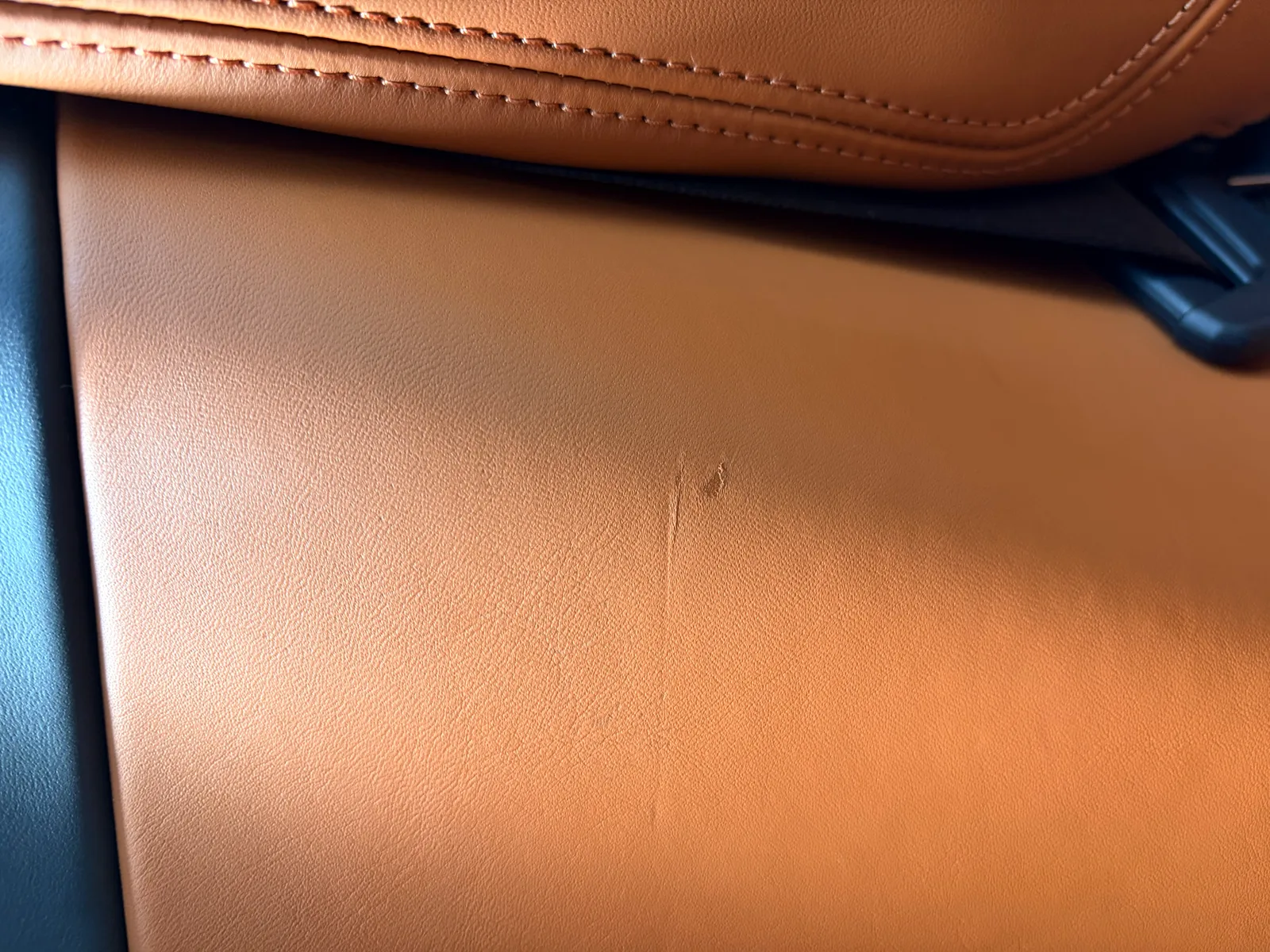 Porsche Cognac leather interior scratch detail before professional restoration