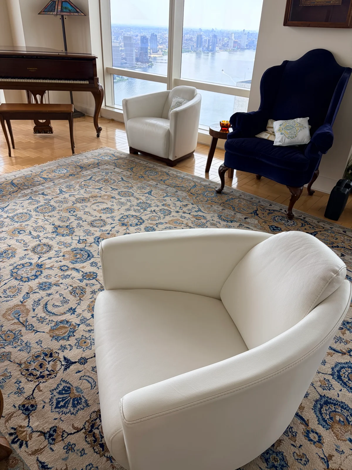 Matching white leather lounge chairs used as a color reference during restoration in Manhattan