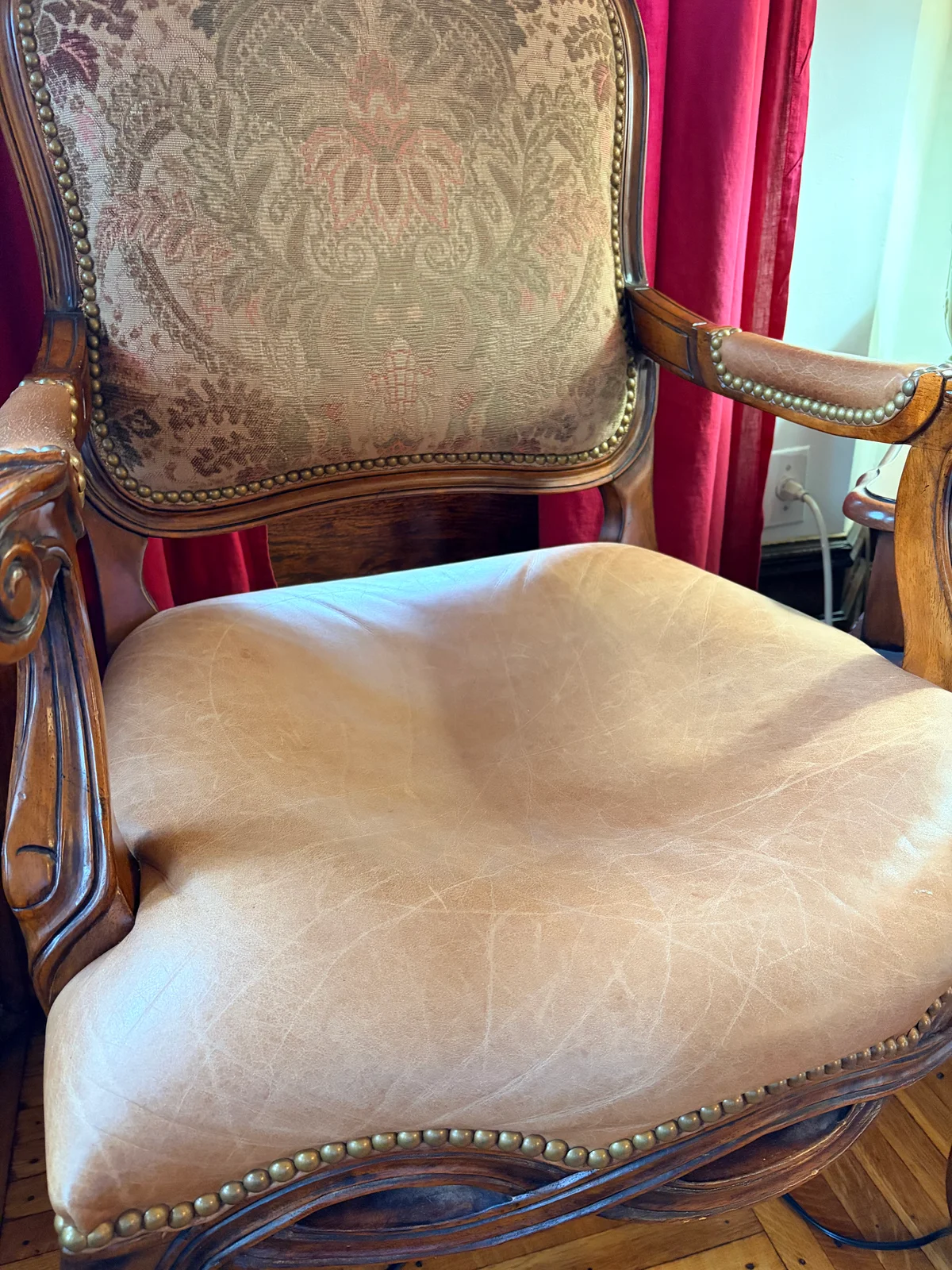Two dining chairs side by side in Brooklyn before foam cushion replacement — leather seat on right showing severe cushion collapse and no support